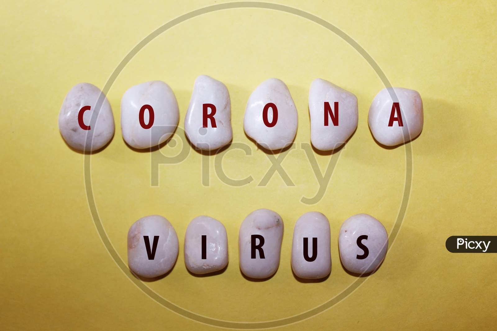 Concept Corona Virus. Corona Virus As A Text With Letters On White Royal Sapphire Rock Pebbles, Template Against A Yellow Background