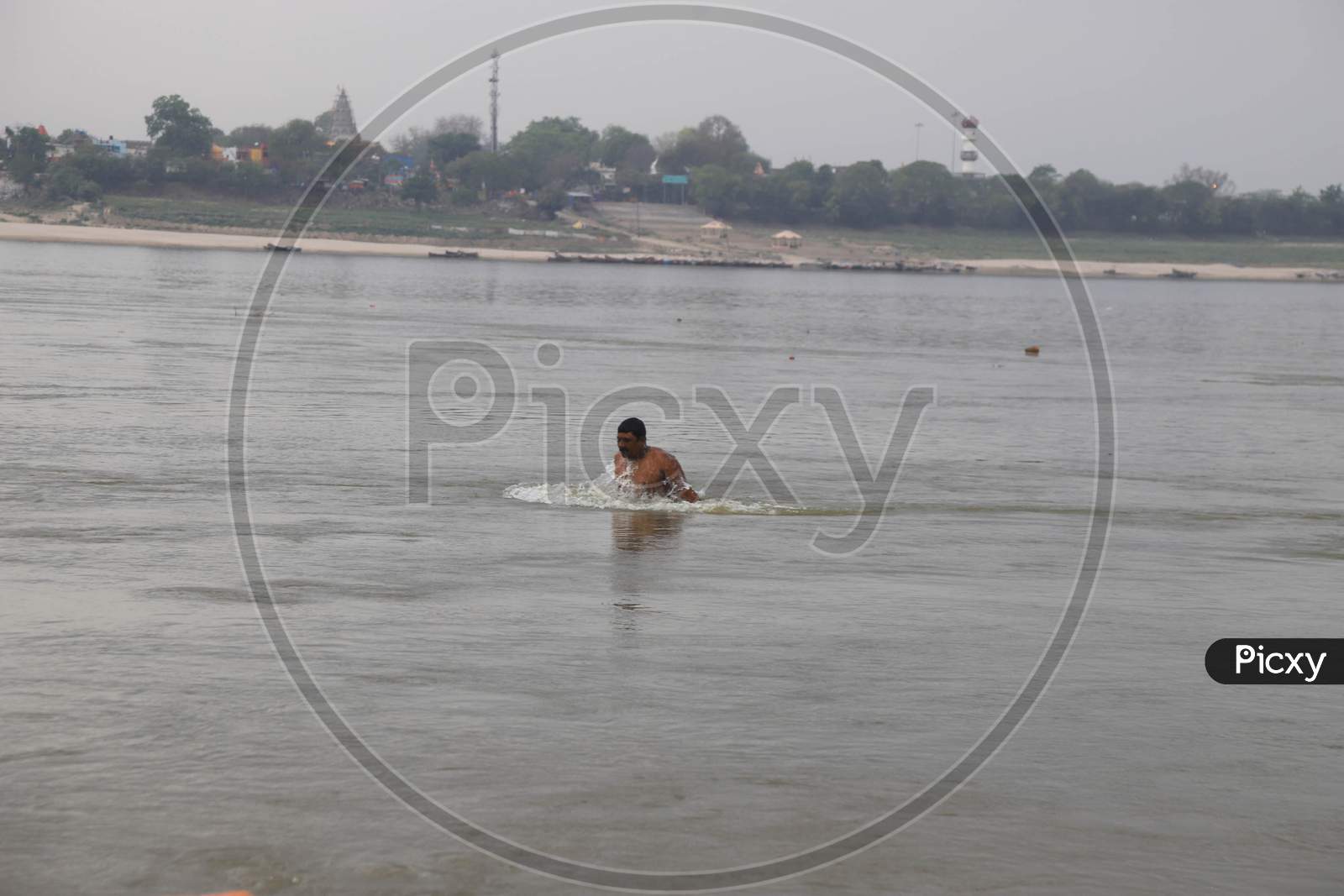 A Man Takes Holy Dip In The Clean Water Of Sangam, Confluence Of Three Water Of Ganga Yamuna And Mythical Saraswati During A 21-Day Nationwide Lockdown To Slow The Spreading Of Coronavirus Disease (Covid-19) In Prayagraj, April 9, 2020.