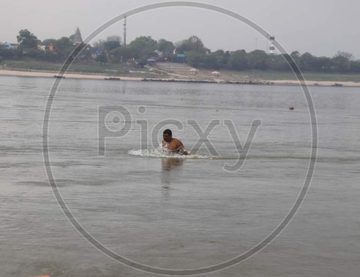 A Man Takes Holy Dip In The Clean Water Of Sangam, Confluence Of Three Water Of Ganga Yamuna And Mythical Saraswati During A 21-Day Nationwide Lockdown To Slow The Spreading Of Coronavirus Disease (Covid-19) In Prayagraj, April 9, 2020.