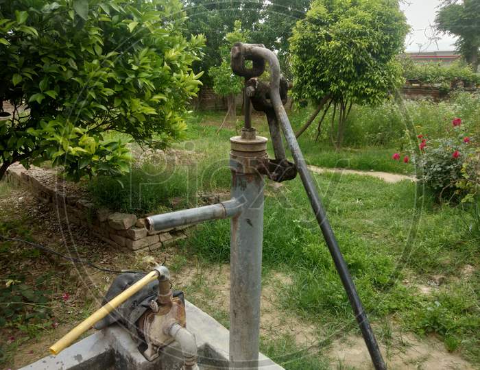 A water tap in village life with trees in background