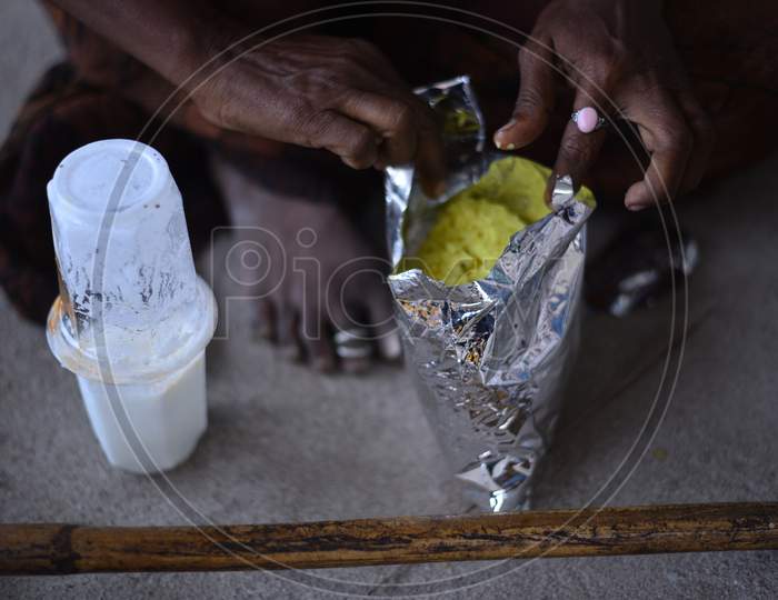 a migrant worker woman eats food that is distributed by donors during nationwide lockdown amid coronavirus pandemic, April 8,2020, Hyderabad.