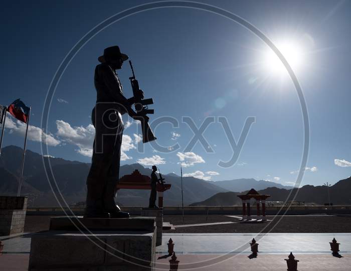 Leh, Kashmir, India - September 20 2019: Silhouetted statue of a soldier at the high altitude war memorial in Leh on bright summer day