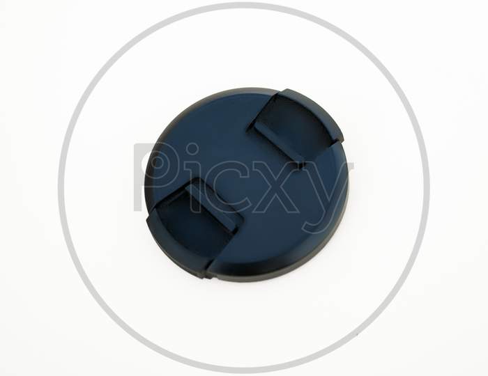Black lens cap isolated on white background. Lens accessory