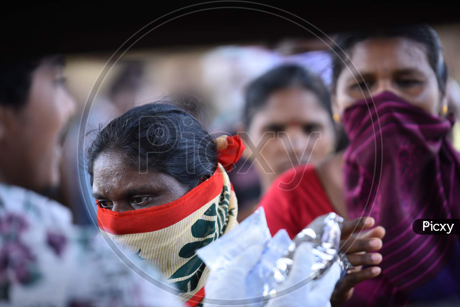 a migrant workers wait in line to collect food packets being distributed by donors as they couldn't find food and work during nationwide lockdown amid coronavirus pandemic, April 8,2020, Hyderabad.