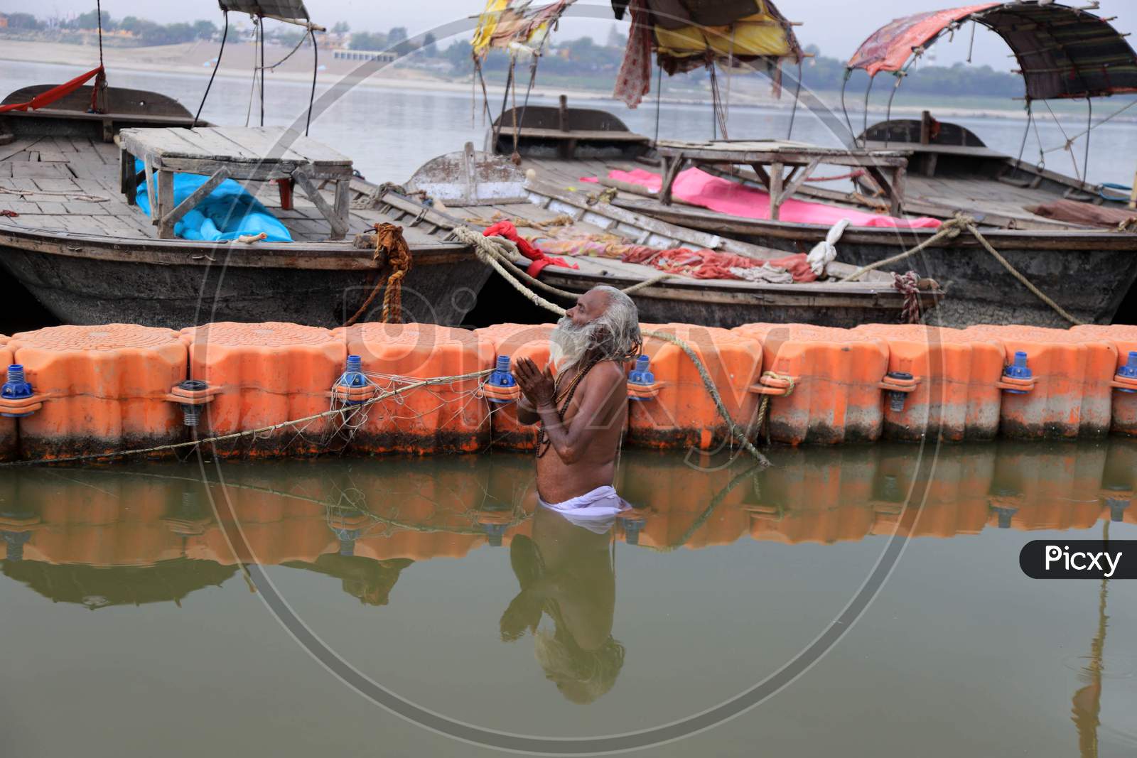 A Sadhu Or Holy Man Offering Prayers After Takesh Holy Dip In The Clean Water Of River Yamuna Uring A 21-Day Nationwide Lockdown To Slow The Spreading Of Coronavirus Disease (Covid-19) In Prayagraj, April 9, 2020.
