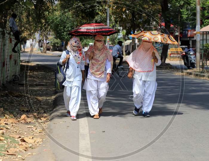 Nurses Using Umbrella Walk In The Empty Road During A 21-Day Nationwide Lockdown To Slow The Spreading Of Coronavirus Disease (Covid-19) In Prayagraj, April 9, 2020