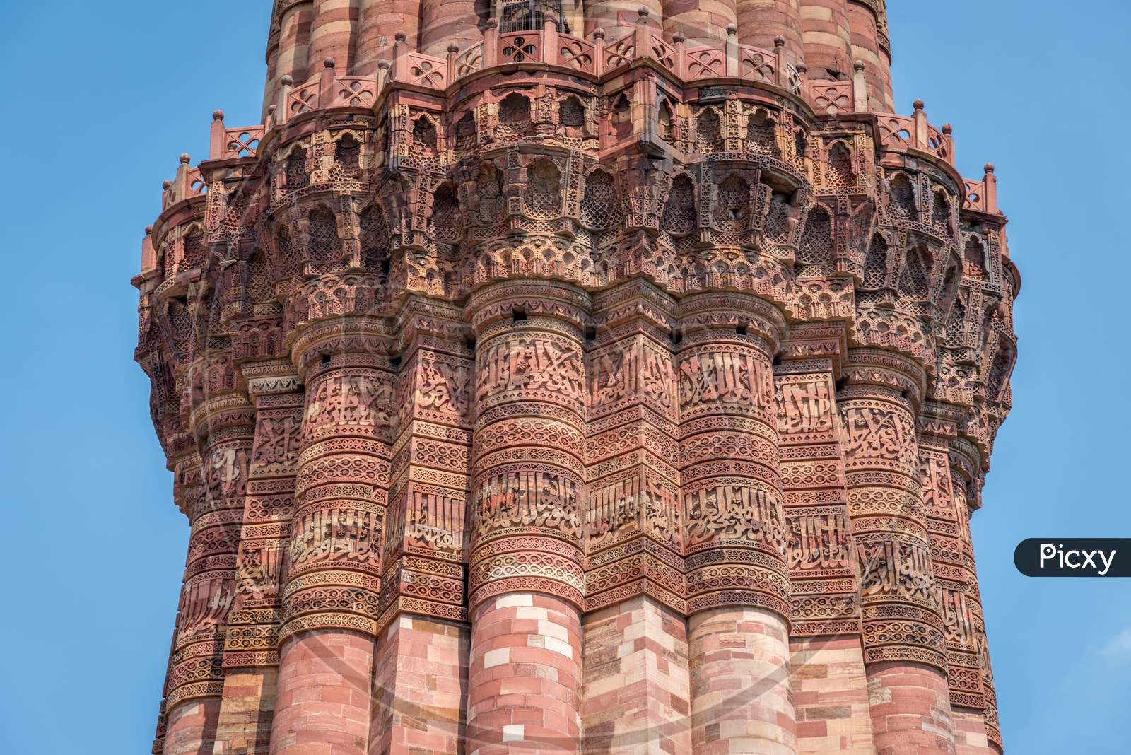 Close up of Qutub Minar tower's balcony against blue sky, New Delhi, India
