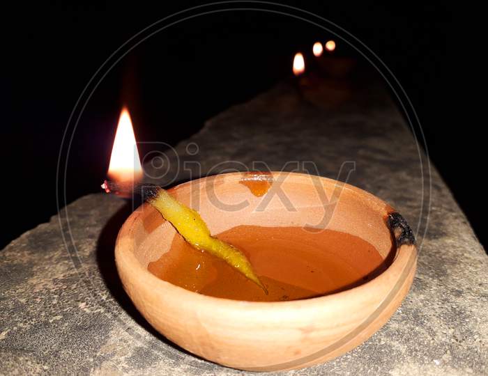 A burning clay lamp filled with mustard oil - Diwali celebration