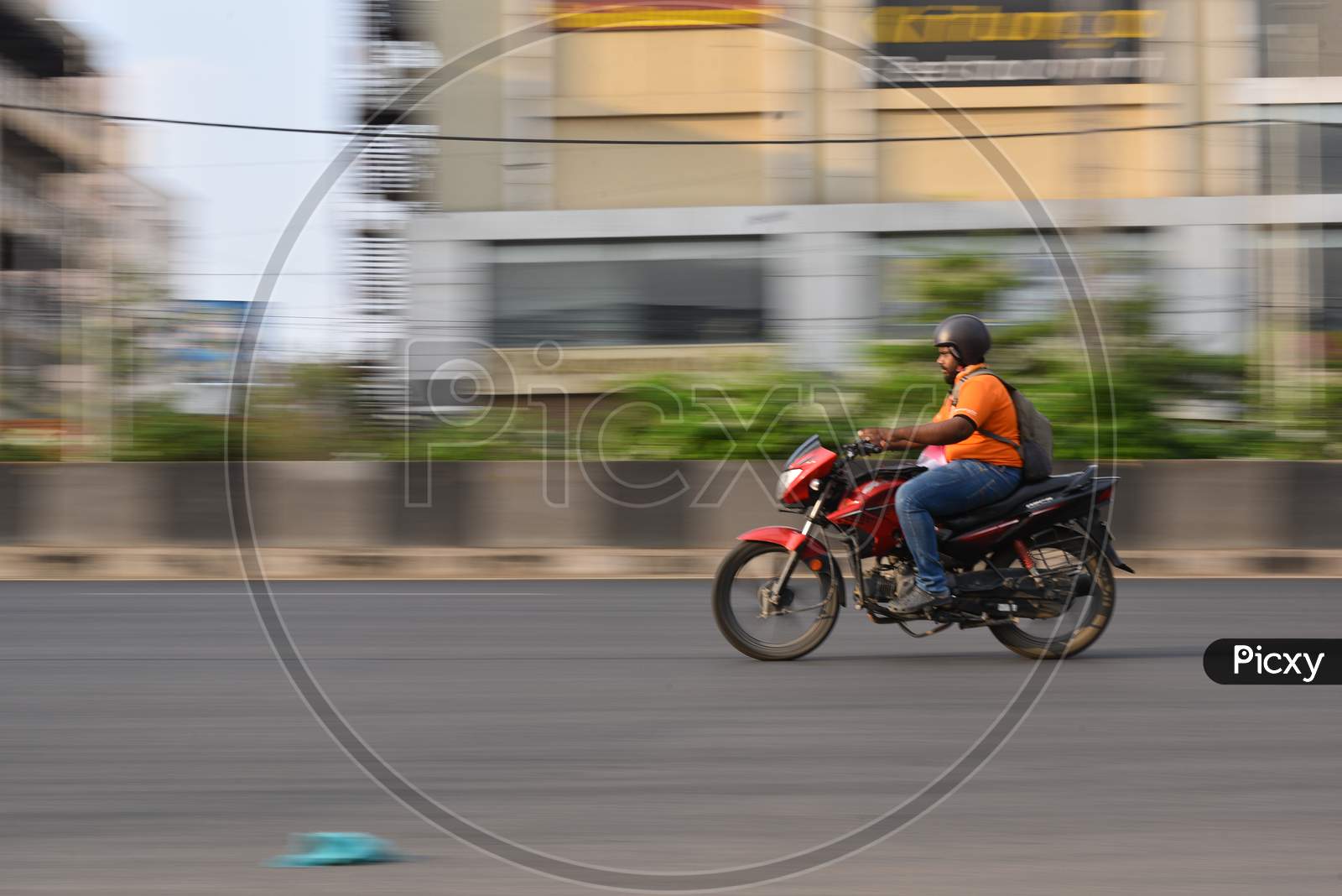 A Zomato delivery boy moves on his vehicle during nationwide lockdown amid coronavirus pandemic, April 8,2020, Hyderabad.
