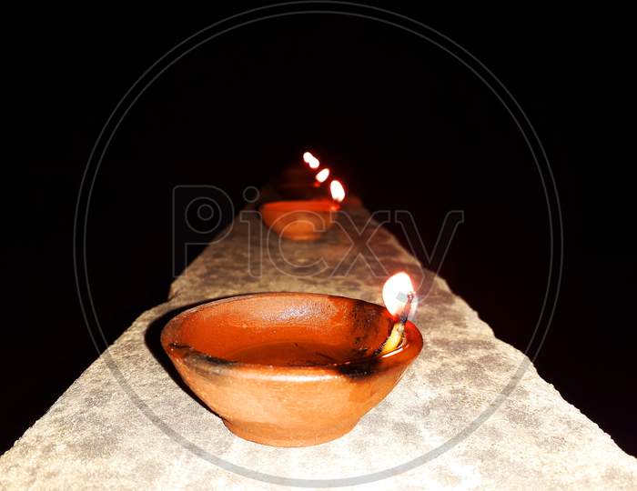 A burning clay lamp filled with mustard oil - Diwali celebration