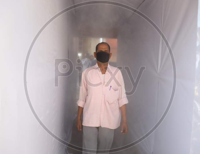 Employees Entering Through Disinfectant Tunnel  or Self Sanitizing Tunnels Arranged At Government Offices During 21-day Lock down Period Due To Corona Virus Or COVID-19 Outbreak in India. Prayagraj