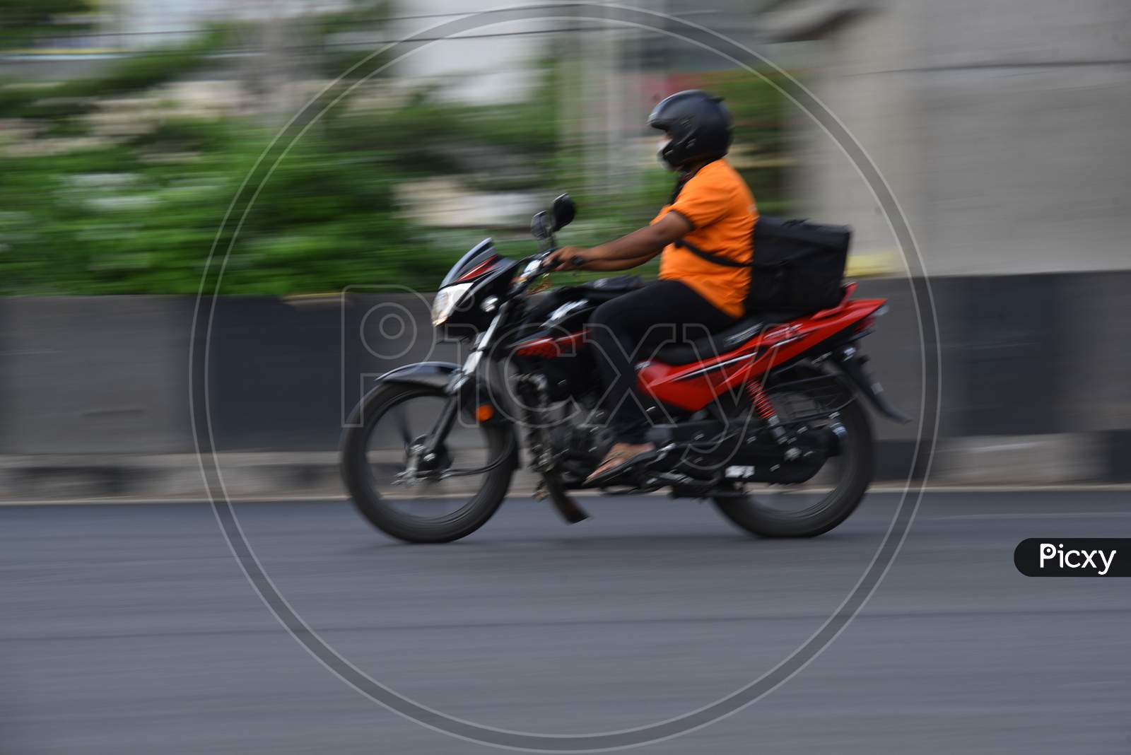 A swiggy delivery boy moves on his vehicle during nationwide lockdown amid coronavirus pandemic, April 8,2020, Hyderabad.