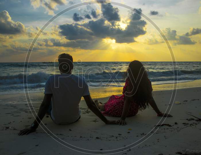 A couple is enjoying the sunset view at Radhanagar beach 