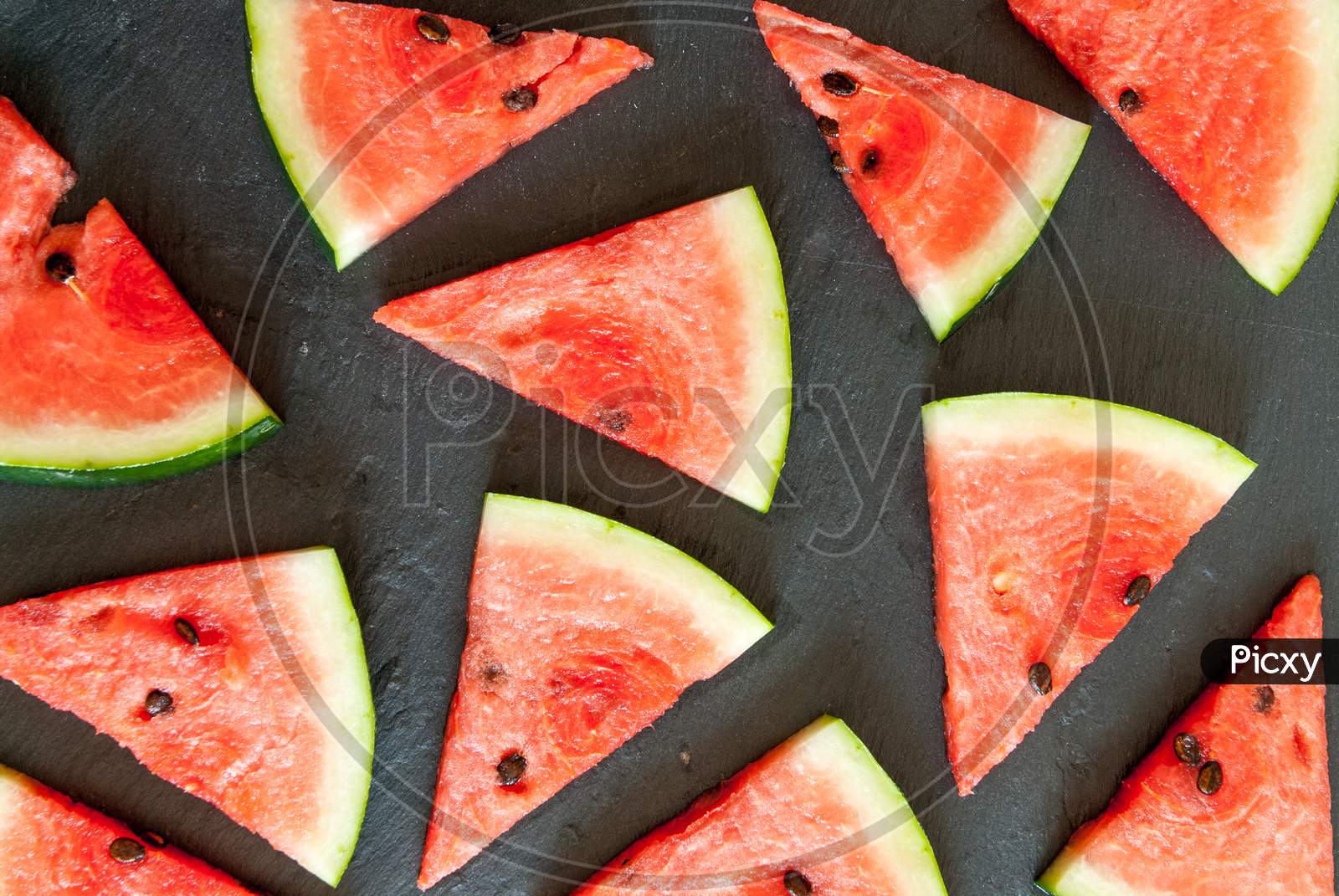 triangular pieces of water melon spread on black