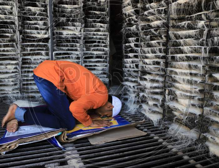 Muslim worker in vermicelli factory offers Friday prayers during the holy month of Ramadan during a government-imposed nationwide lockdown as a preventive measure against the COVID-19 or Coronavirus, at a factory, in Prayagraj on May 1, 2020.