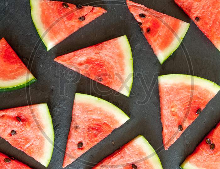 triangular pieces of water melon spread on black