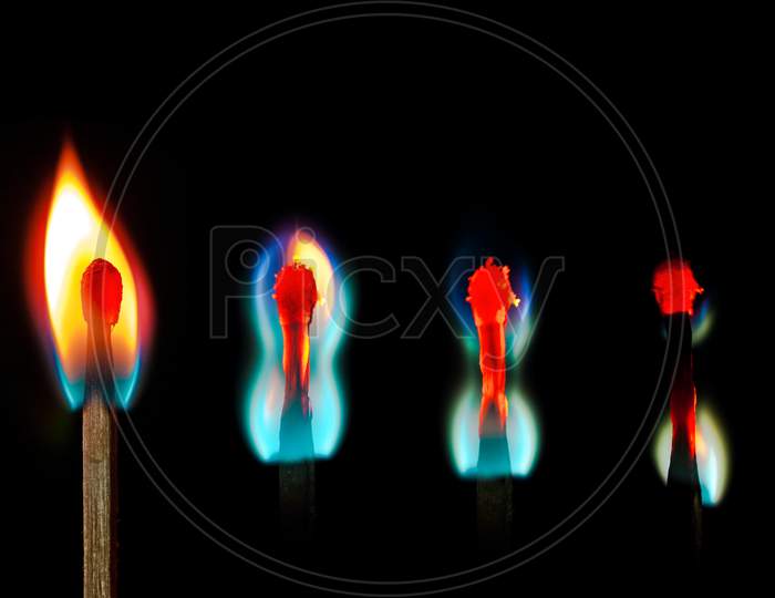 burning candlesticks on black abstract conceptual photo