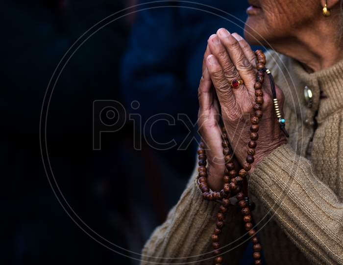 Lady From Buddhist Religion Praying For Better Future With Prayer