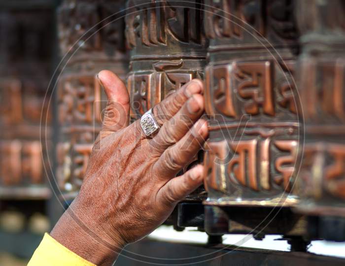 Prayer'S Wheel With Mantra "Om Mani Padme Hum", An Ancient Buddhist Mantra. In English, This Rhythmic Chant Literally Translates To “Praise To The Jewel In The Lotus.”
