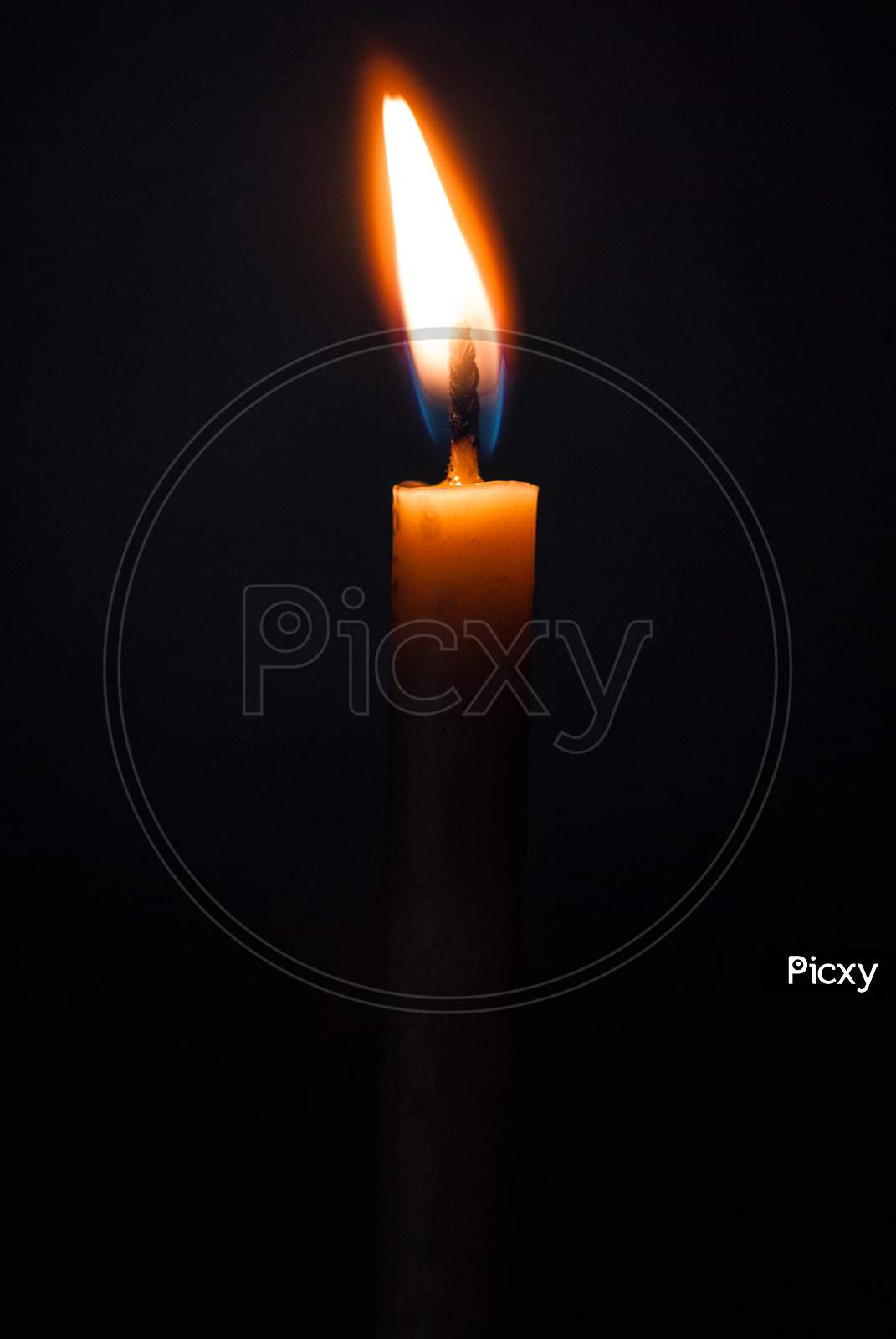 burning candlestick on black abstract conceptual photo