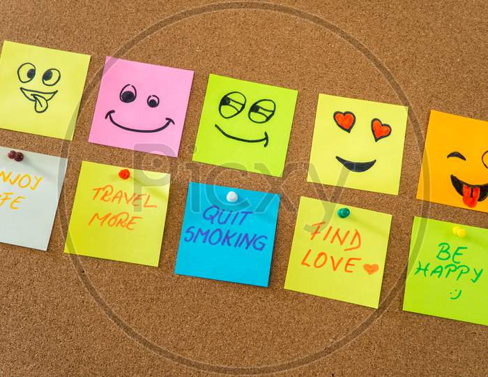 note papers with smiley faces on cork board office concept photo
