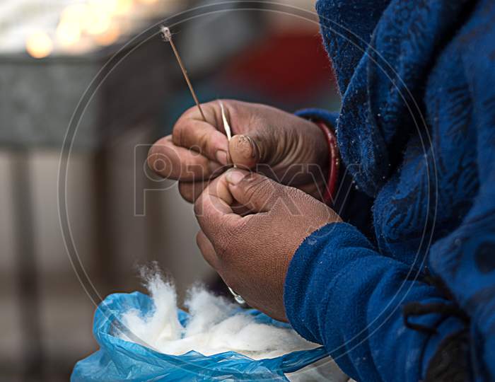 Lady Preparing Cotton Wick For Butter Lamp