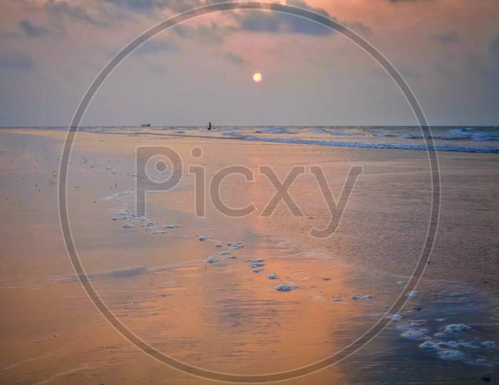 Beautiful sunrise in cloudy sky at clean and calm sea beach of Mandarmani, Digha, West Bengal