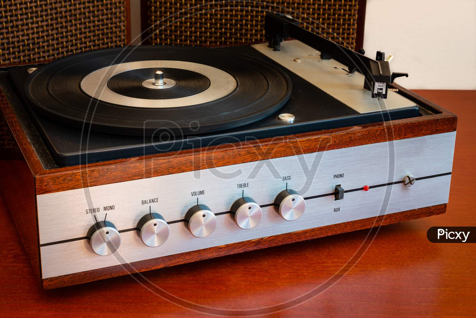 Vintage turntable made of wood with speakers on an old table