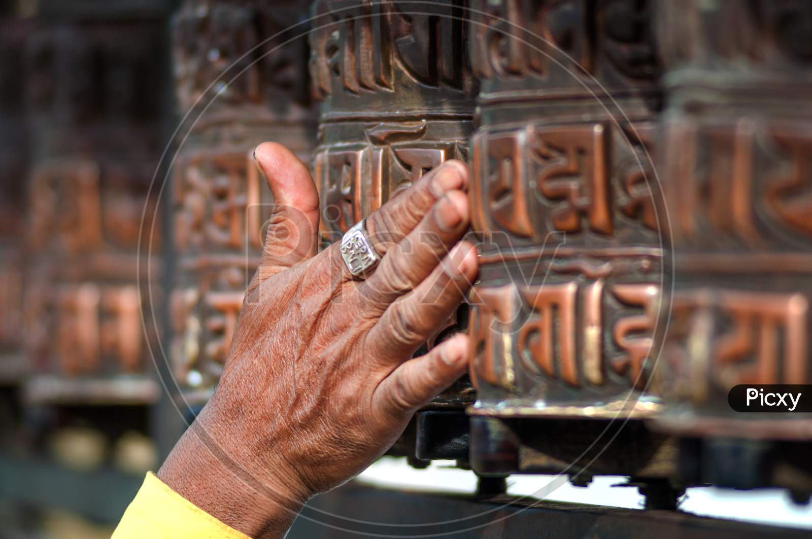 Prayer'S Wheel With Mantra "Om Mani Padme Hum", An Ancient Buddhist Mantra. In English, This Rhythmic Chant Literally Translates To “Praise To The Jewel In The Lotus.”