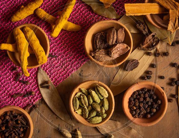 Different spices like cinnamon turmeric and many more spices 
