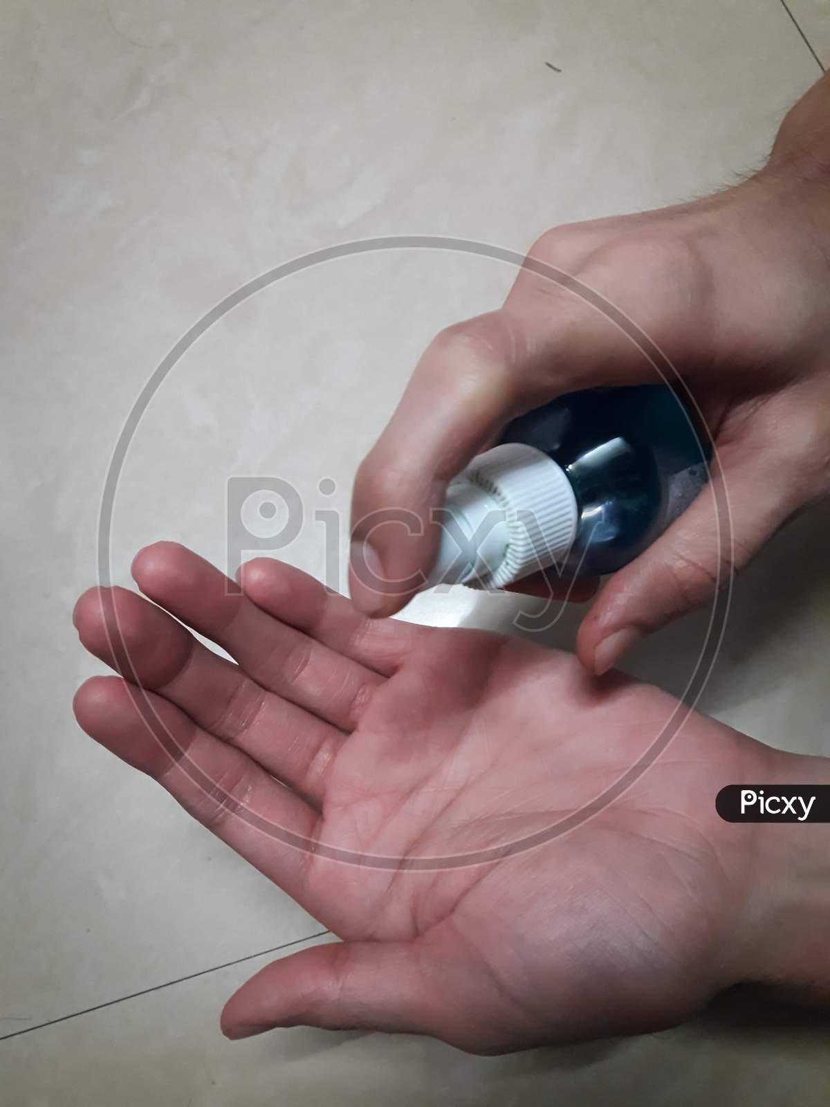Disinfecting The Hand With Sanitizer to avoid the spread of COVID 19 or coronavirus With white Background