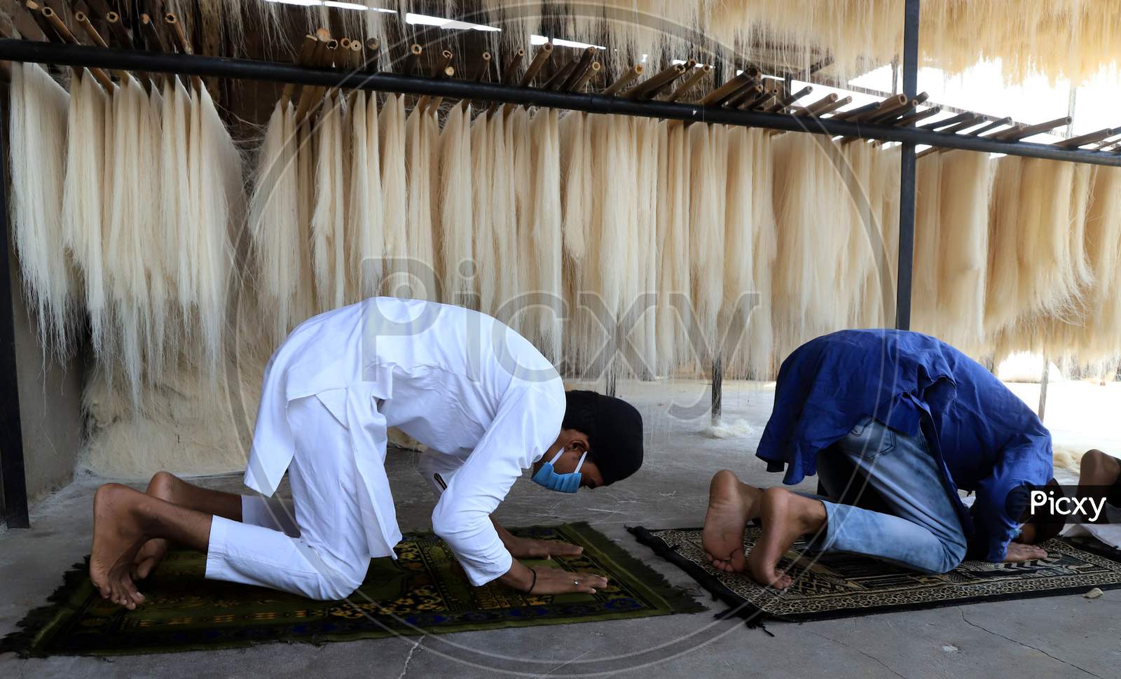 Muslim workers in the vermicelli factory offer Friday prayers during the holy month of Ramadan during a government-imposed nationwide lockdown as a preventive measure against the COVID-19 or Coronavirus, at a factory, in Prayagraj on May 1, 2020.