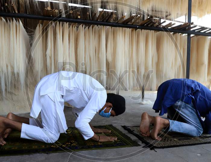 Muslim workers in the vermicelli factory offer Friday prayers during the holy month of Ramadan during a government-imposed nationwide lockdown as a preventive measure against the COVID-19 or Coronavirus, at a factory, in Prayagraj on May 1, 2020.