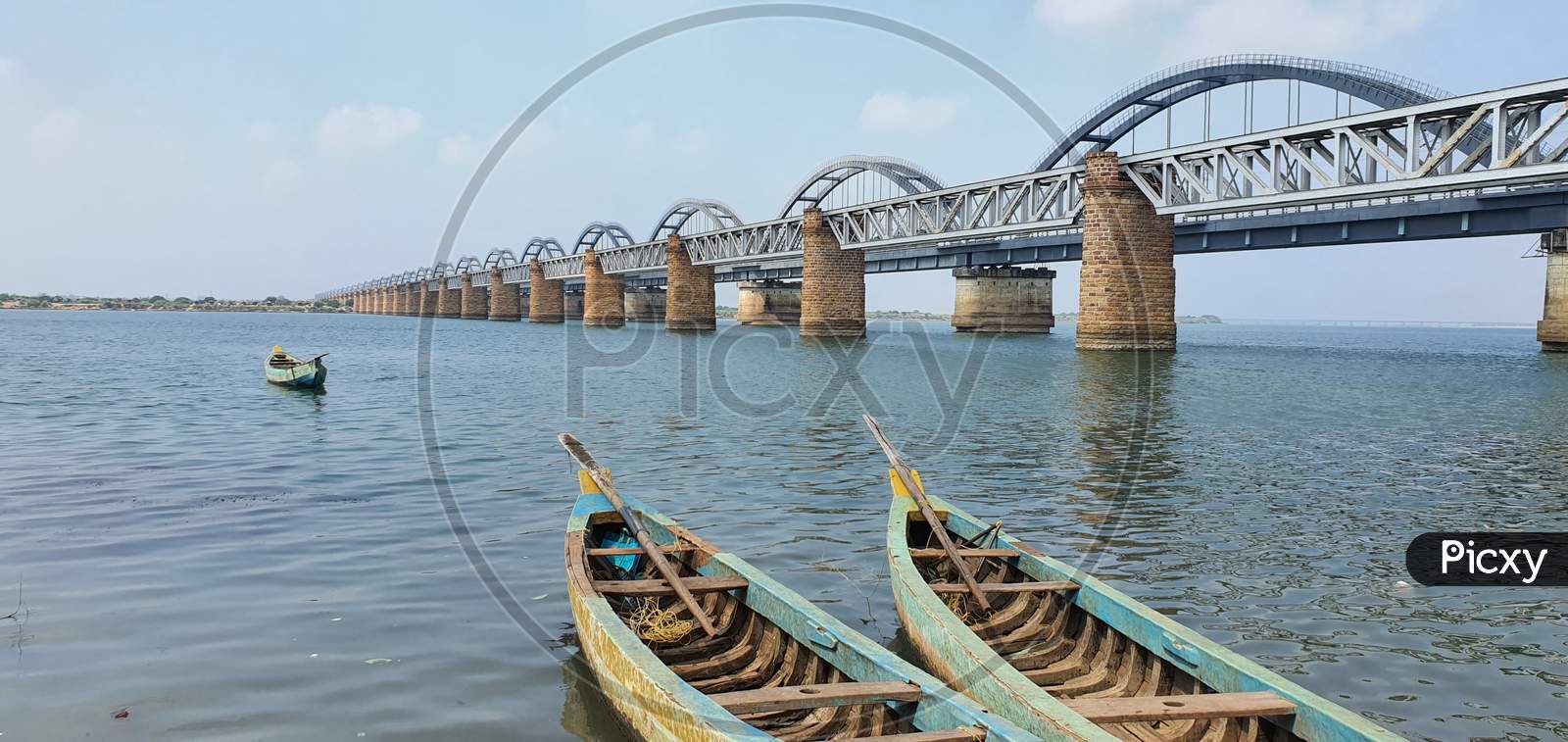 Boats against the backdrop of railway bridges across the Godavari river