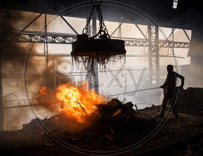 Workers Melt Metal Scraps In The Furnace Of A Steel Mill To Produce Rods In Demra, Dhaka, Bangladesh.