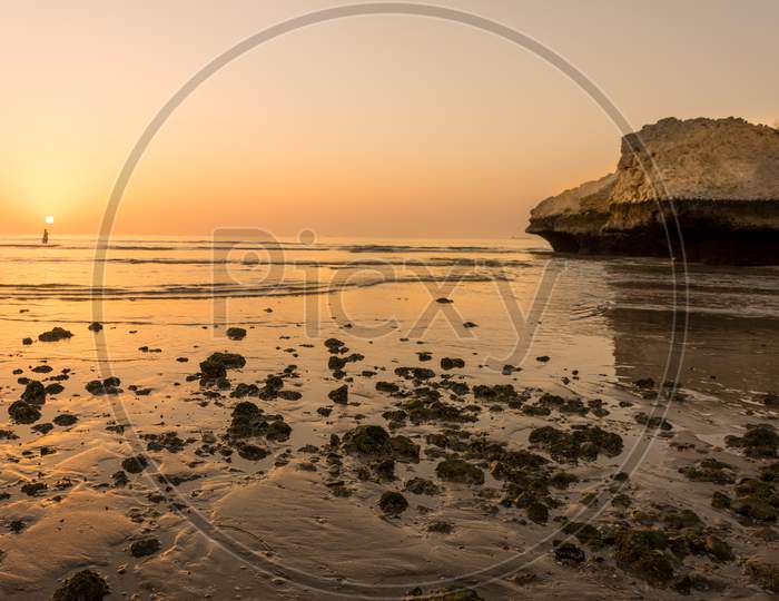 Rocky sea beach sunset in Oman.