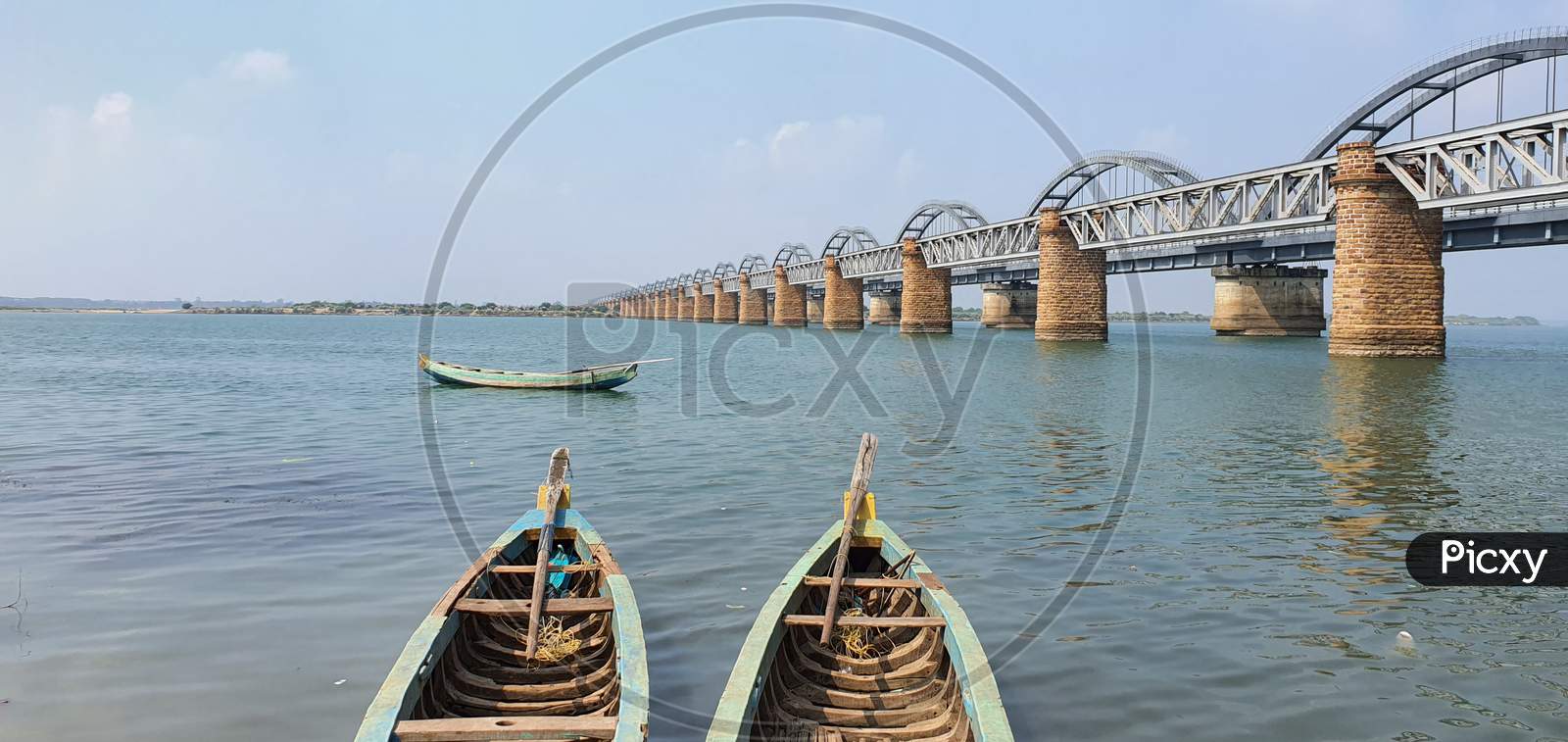 Fishing boats on Godavari river against the backdrop of bridges