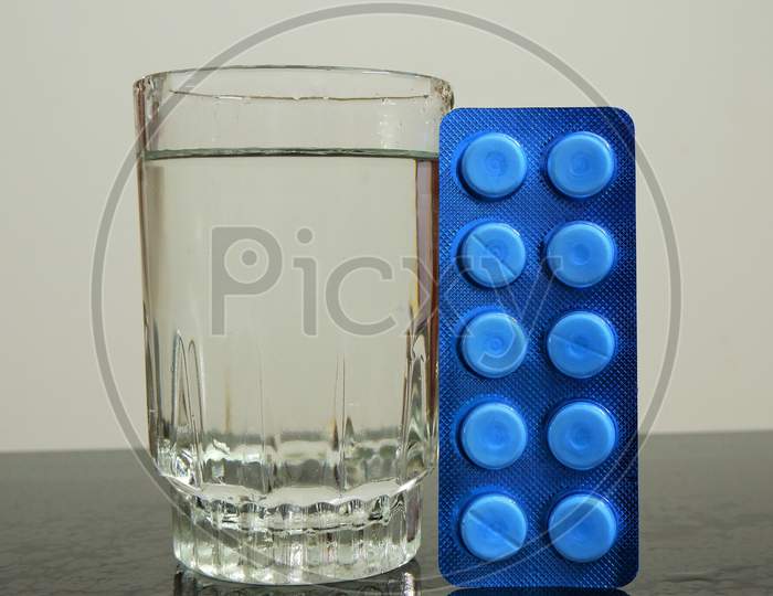 tablet with glass of water
