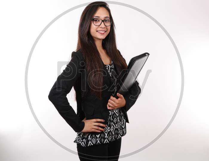A Young Female Executive Wearing Glasses Holds Her Portfolio.