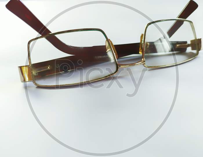 Folded eyeglasses on white background.
