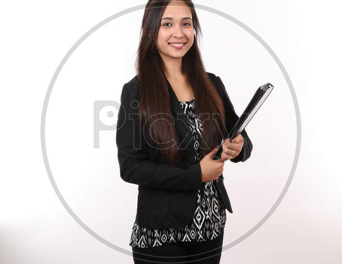 An Attractive Hispanic Employee Holds Her Black Portfolio As She Smiles.