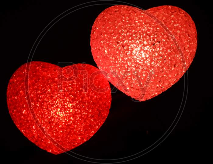 Red love heart symbol on black background