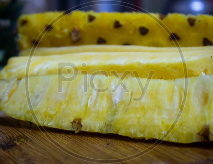 Pineapple Skin Removed And Sliced Into Long Pieces. Pineapple Is Healthy And Good In Vitamins. Use For Healthy Snack Concept.