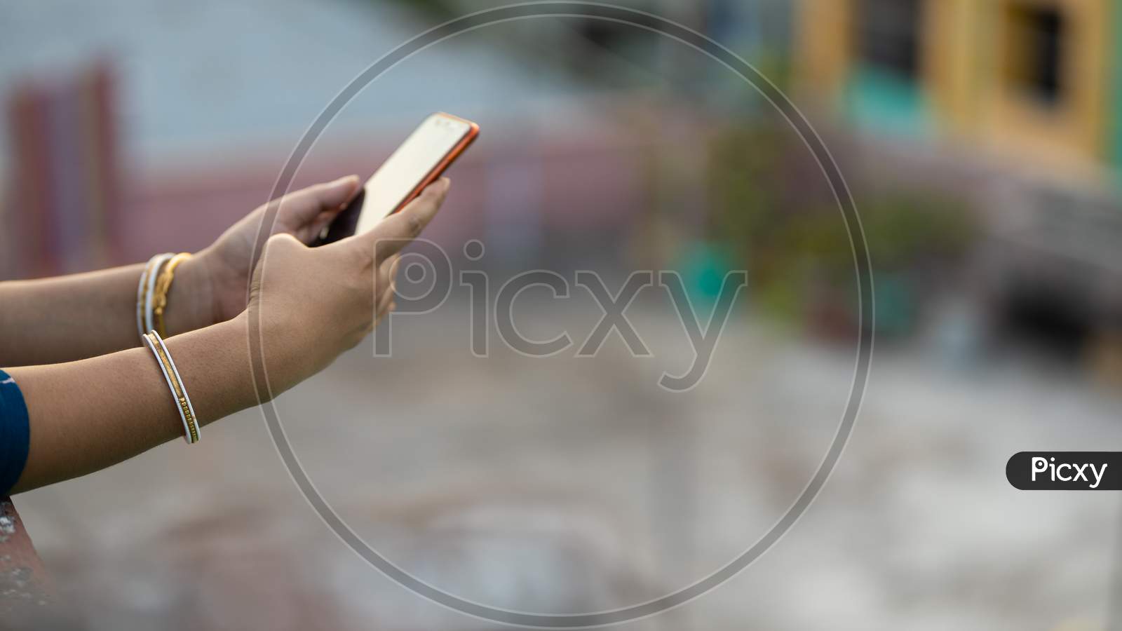 Woman Hand Browsing On Mobile Phone Outdoors