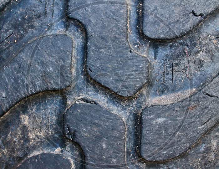 Close up view on deep tire treads at big rubber wheels