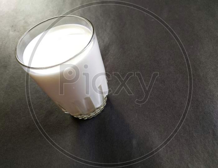 A glass of milk on black background.