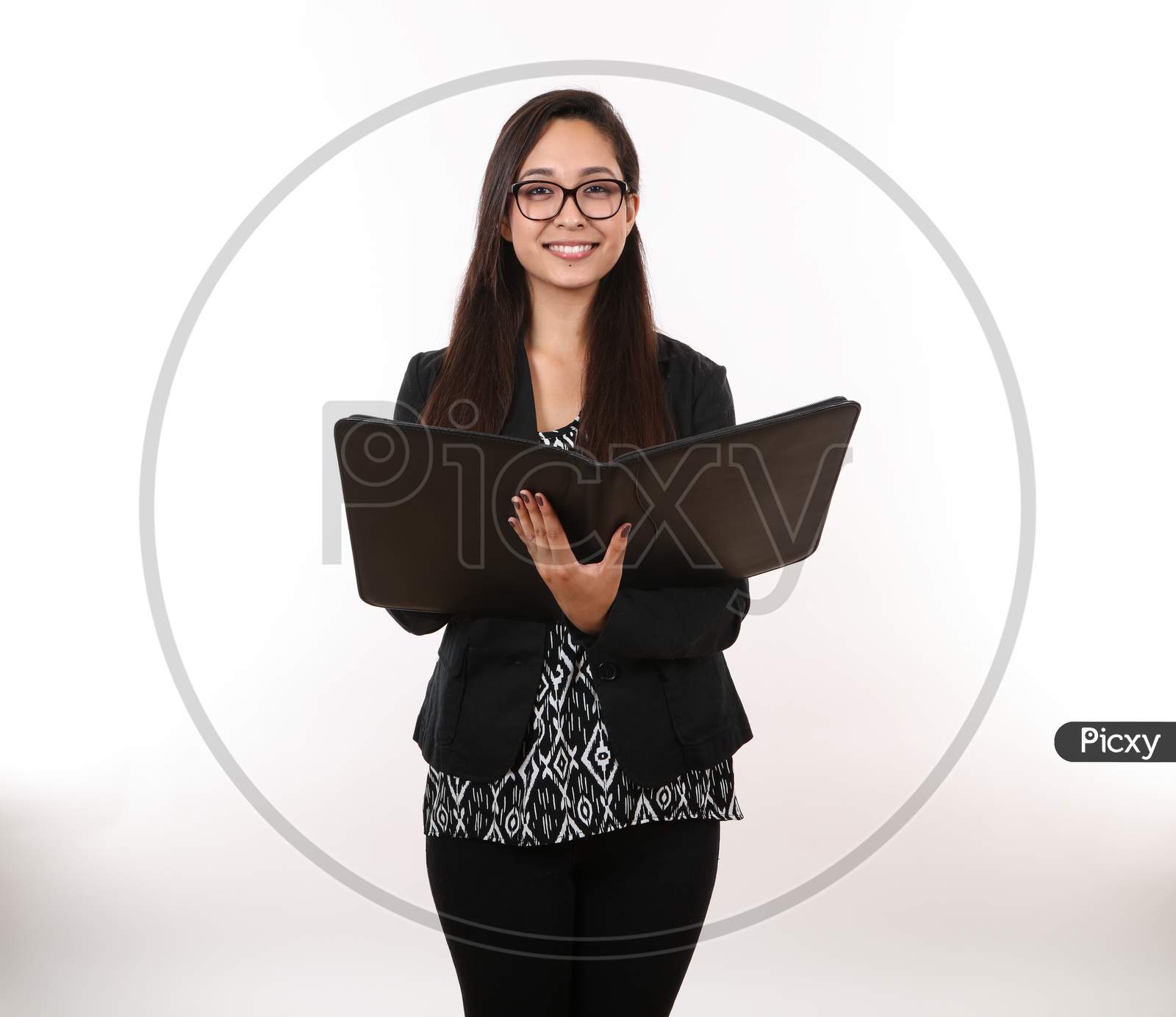 An Attractive Young Executive Prepares To Take Notes In Her Portfolio.