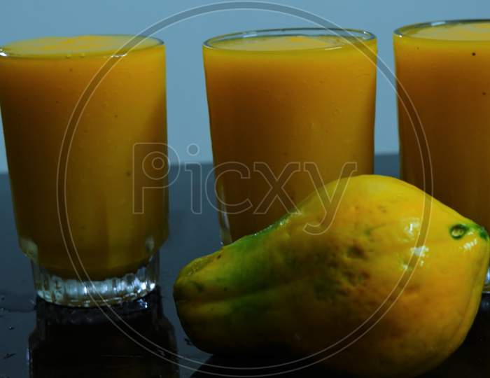 papaya juice with papaya on the table