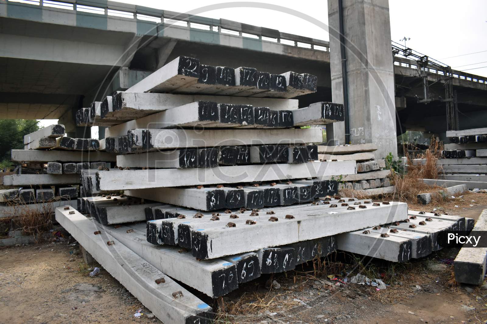 Pile of prefabricated concrete slab used in train track in India.