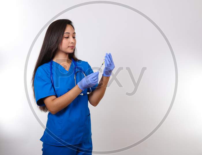 A Young Nurse Prepares A Shot For Her Patient.